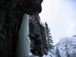 Jason sizes up the crux pillar on "Cave Route" - Hyalite Canyon