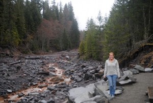 Michelle stands next to a muddy creek in Mt. Rainier National Park.